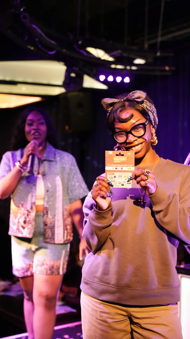 Winner holding up her gift card