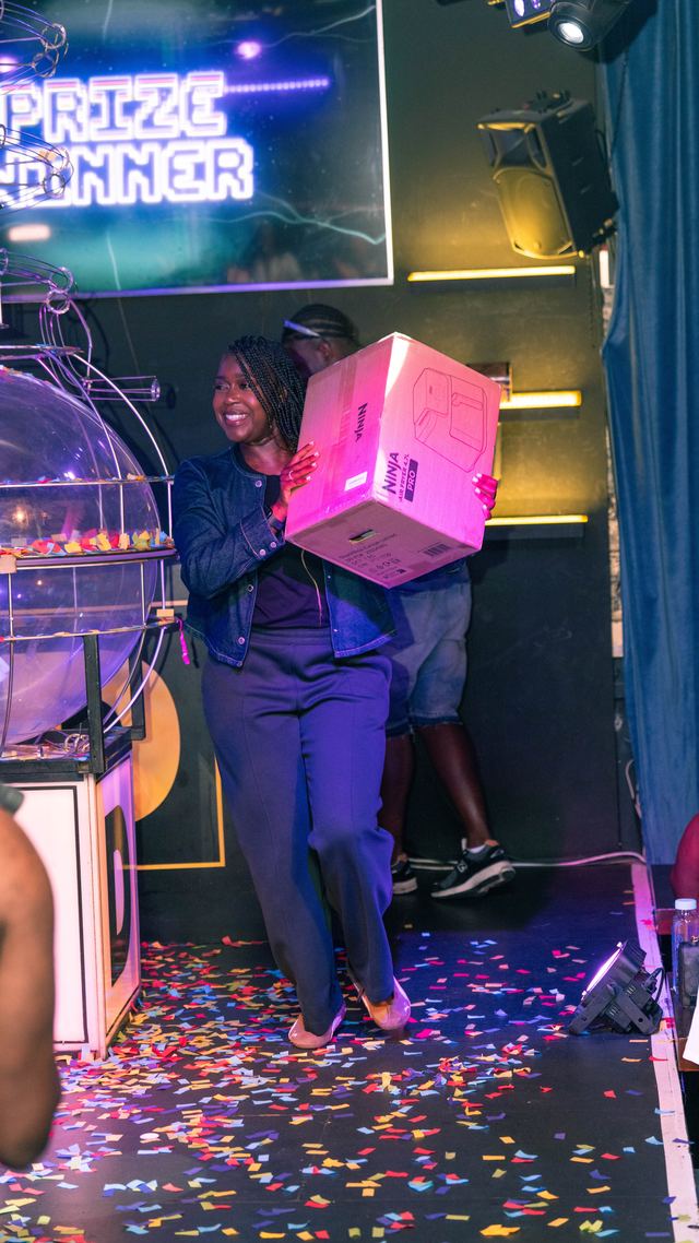 Winner carrying her prize off stage
